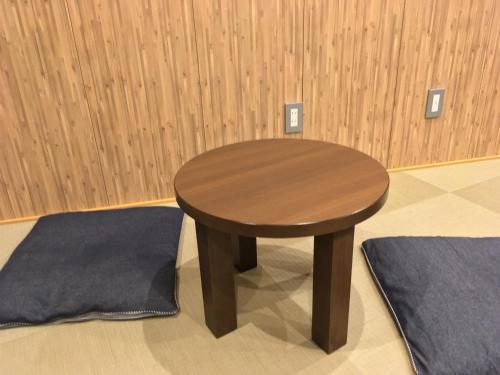a small wooden table in a room with wooden walls at Tokyo Guest House Itabashi-juku in Tokyo