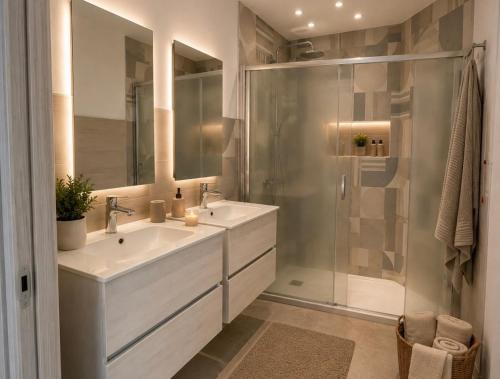 a bathroom with two sinks and a shower at Altea in Taurianova