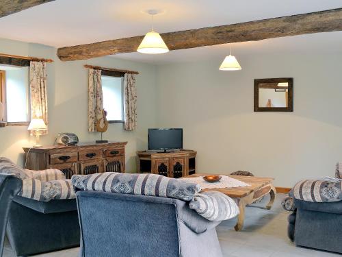 a living room with a couch and a table at Chive - E4326 in Catfield