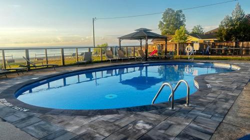 a swimming pool with a view of the ocean at Wasaga Daze - Unit B in Wasaga Beach