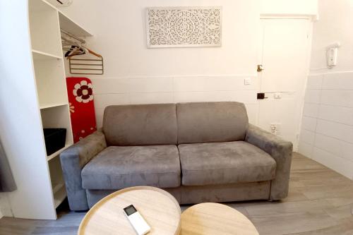 a living room with a couch and a table at Bright and quiet studio in Nice in Nice