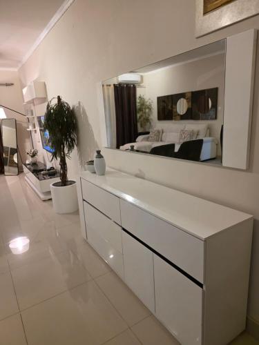 a white bathroom with a large mirror above a sink at L28 double up apartament in Camama