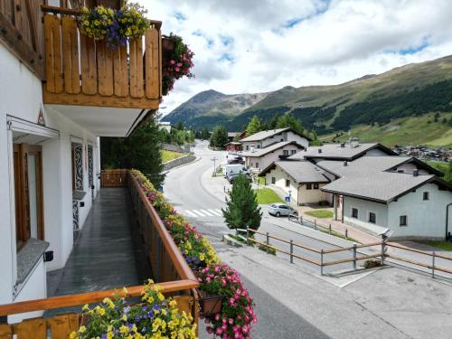 a balcony with flowers on the side of a building at Hotel Duc De Rohan in Livigno