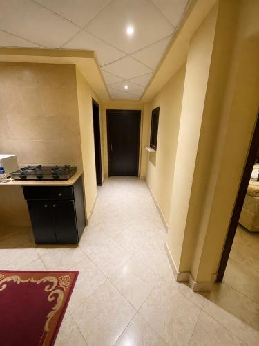 an empty room with a hallway with a black door at El wadi Pearl Residence in Ain Sokhna