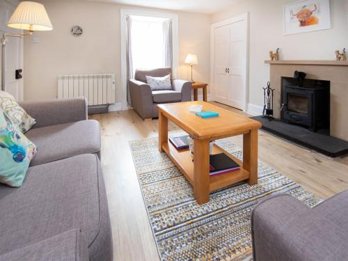 a living room with a couch and a coffee table at Solus Na Madainn in Tain