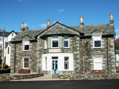 an old stone house with a sign on it at 2 Harney Peak in Portinscale