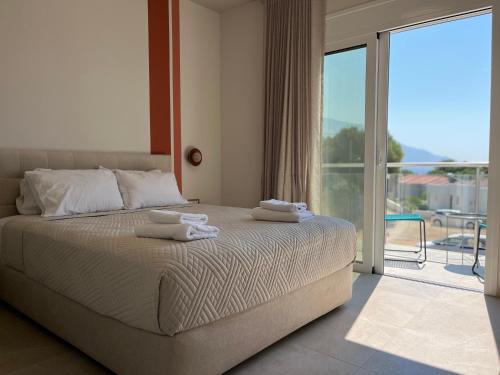 a bedroom with a bed with towels on top of it at Zefy's Scenic Oasis in Pesádha