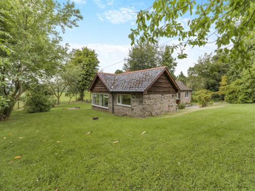 a small stone house in a field of grass at Steep Holm in Kington
