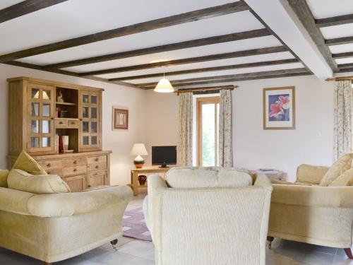 a living room with couches and chairs and a tv at Coriander - E4323 in Catfield