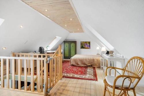 a attic bedroom with a bed and a staircase at SJ214-Fredericia-Lillenaes-71 in Fredericia