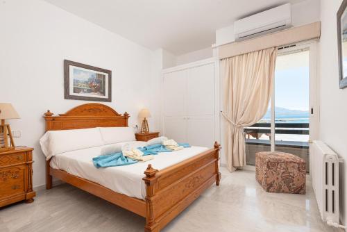 a bedroom with a bed and a large window at Port de Pollenca Esmeralda 3 in Port de Pollensa