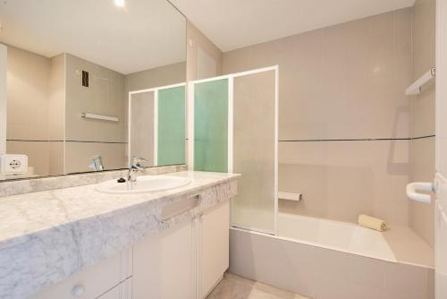 a bathroom with a sink and a shower and a tub at Port de Pollenca Esmeralda 3 in Port de Pollensa