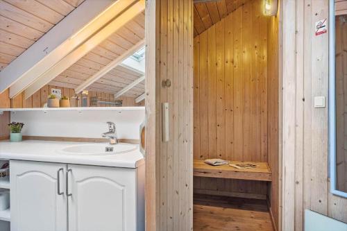 a bathroom with a sink and a wooden wall at SJ225-Hejls-Humlevaenget-6 in Hejls