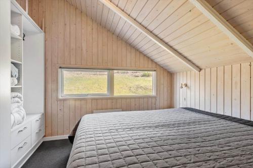 a bedroom with a large bed and a window at SJ225-Hejls-Humlevaenget-6 in Hejls