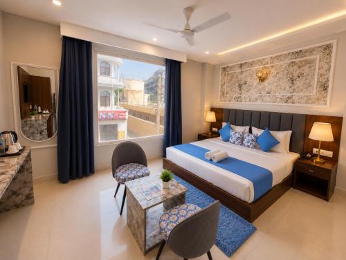 a bedroom with a large bed and a living room at Hotel Royal Dot Managed By Sitara Group, Haridwar in Haridwār