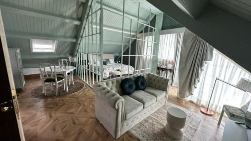a living room with a couch and a table at Hotel Boutique Cata & Rose - Exclusivo y tranquilo en O Grove in O Grove