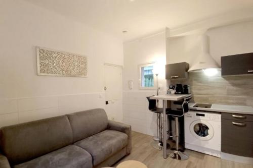 a living room with a couch and a sink at Bright and quiet studio in Nice in Nice