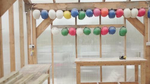 a bunch of colorful lights hanging over a table at The Common Knowledge Centre in Kilfenora