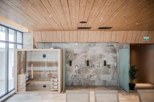 a room with a stone wall and a wooden ceiling at Zyra Blue Heart Pool & Spa in Năvodari