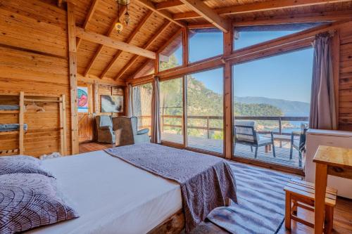 a bedroom with a bed and a large window at 11-11Shambala in Fethiye