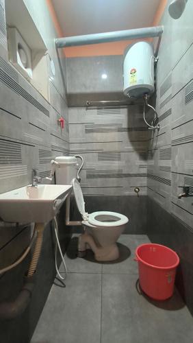 a bathroom with a toilet and a sink at Sai krishna residency in Pithāpuram