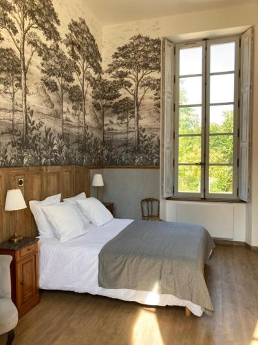 a bedroom with a bed and a wall with trees at Château de la Mothe in Olivet