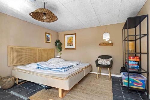 a bedroom with a bed and a chair in it at SJ277-Haderslev-Kelstrup-Norreskov-36 in Haderslev