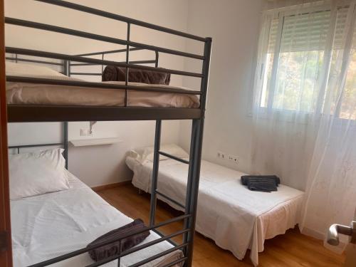 a room with two bunk beds and a window at 3 Bed Chalet-Pool-Pets-Hot Tub-Parking-Garden in Chiva