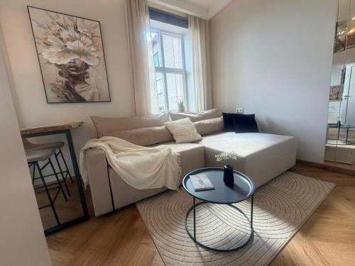 a living room with a couch and a table at Keskväljaku Studio apartment in Võru