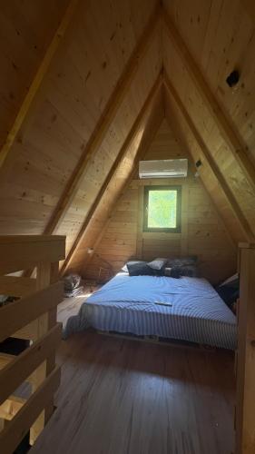 a bedroom with a bed in a attic at Nota A Frame in Šakotinac