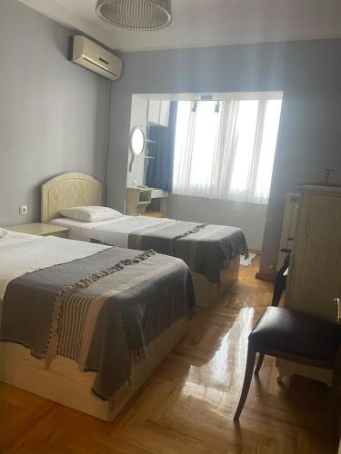 a room with two beds and a mirror in it at Apartment old Batumi in Batumi