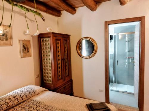 a bedroom with a bed and a mirror at Ca' Merla affittacamere in Morbegno