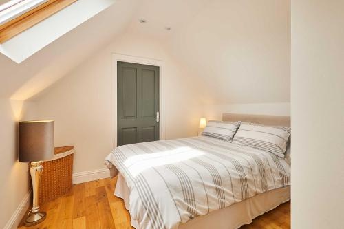 a bedroom with a bed and a green door at Host & Stay - The Spinney in Consett