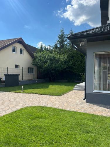 a house with a yard with a brick driveway at StGeorge Retreat in Sângeorgiu de Mureș