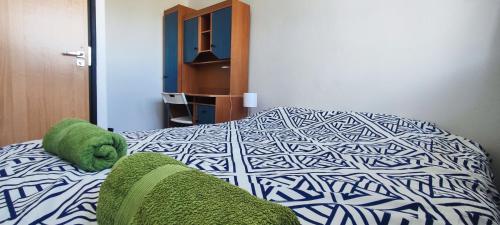 a bedroom with a bed with green towels on it at Rynek - Nowy Targ in Wrocław