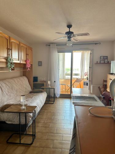 a living room with a couch and a table at Appt Cap d'Agde in Agde