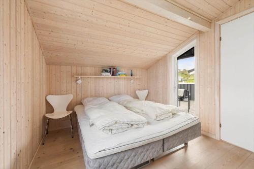 a bed in a small room with a window at LN602-Hjorring-Harerenden-71 in Hjørring
