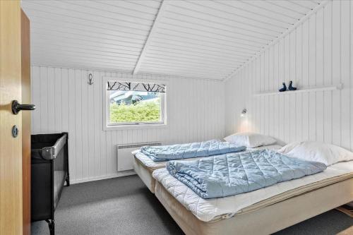 a bedroom with two beds and a window at SJ253-Haderslev-Vikaerparken-89 in Haderslev