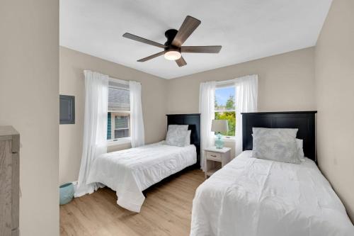 a bedroom with two beds and a ceiling fan at Between Tides 2BR Walk to Beach Unit C in Seaside Park