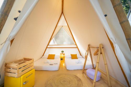 a room with two beds in a tent at Kampaoh Paloma in Tarifa