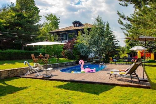 a swimming pool with a pink flamingo in a backyard at Дедовата Къща in Dedovo