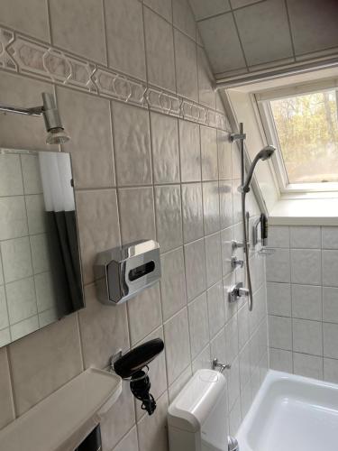 a bathroom with a toilet and a sink at Pension und Restaurant La Casa in Undeloh