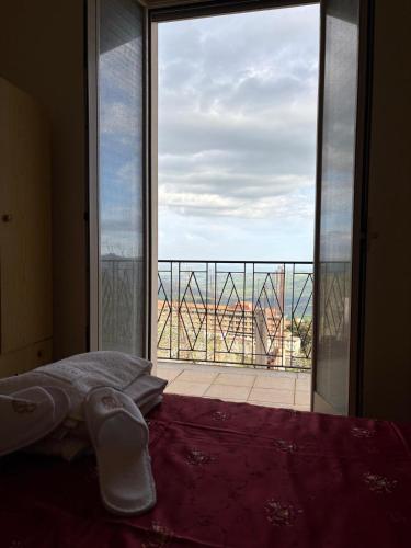 a room with a large window with a bed and a view at Troina rooms in Troina