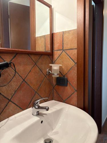 a white sink in a bathroom with a mirror at Troina rooms in Troina