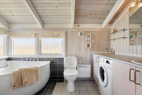 a bathroom with a tub and a toilet and a sink at LN1789-Hjorring-Indemarken-44 in Hjørring