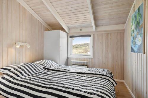 a bedroom with a bed in a room with a window at LN1789-Hjorring-Indemarken-44 in Hjørring