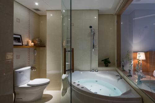 a bathroom with a tub and a toilet and a shower at Silverland Yen Hotel in Ho Chi Minh City