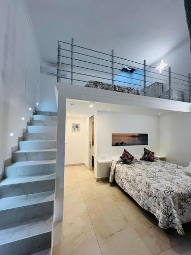 a bedroom with a staircase and a bed with a bedspread at b&b da Laura in Ponza