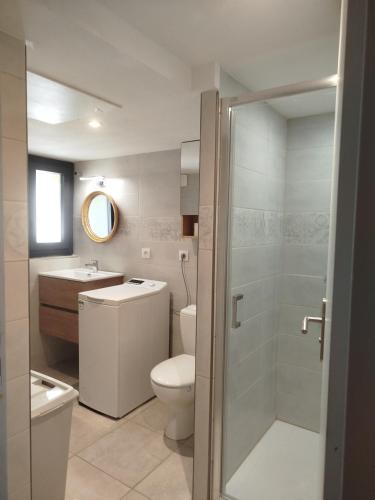 a bathroom with a toilet and a sink and a shower at Lénola en Ardèche in Labeaume