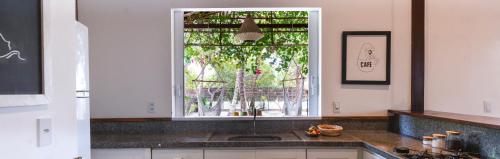 a kitchen with a sink and a window at Casa Shaka in Atins